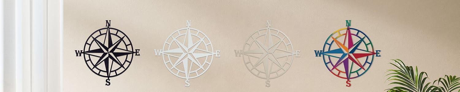 Four ESTART compass roses in black, gold and copper hung in a row on a sand-colored wall